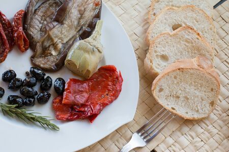 Italian antipasti as dinner appetizer. Tomatoes, Olives, paprika and more.の写真素材