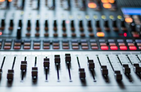 Professional music production in a sound recording studio, mixer desk