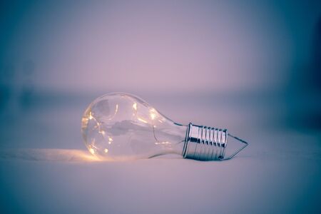 LED light bulb is lying in the bed. Symbol for ideas and innovation.の写真素材