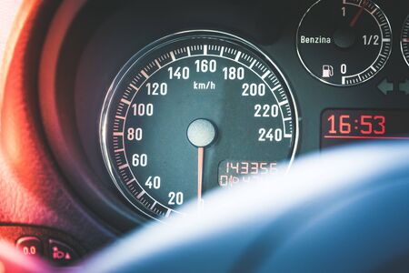 Closeup of the dashboard of a sports car, tachometer and fuel indicator