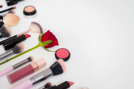 Set of makeup brushes and other accessories. Lipstick, mascara, nail polish, eyeshadow, powder, eyelash and foundation. Products for makeup on white background, top view.の写真素材