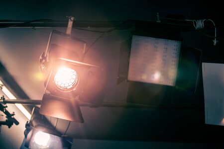 Professional orange studio spotlight hanging on the ceiling.の写真素材