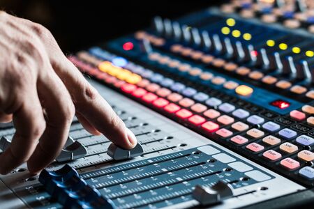 Professional music production in a sound recording studio, mixer desk