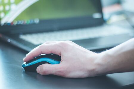Close up of computer mouse used by a male handの写真素材