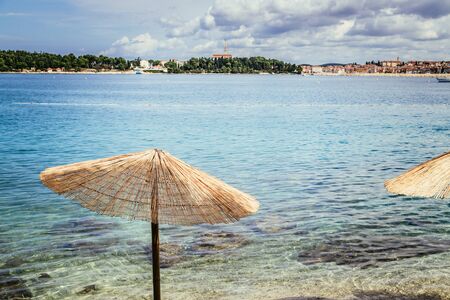 Sunshade and clear water on the beach, Lone Bay, Croatiaの写真素材