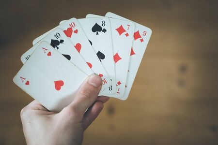 Man is playing cards, cutout of his hands