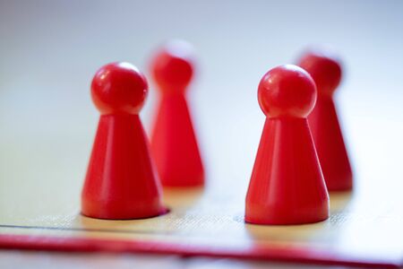Meeples on a board, ready for playing a parlor game, ludo の写真素材