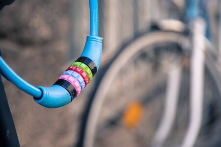 Close up picture of colorful bike lock, bike in the blurry backgroundの写真素材