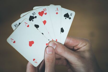 Man is playing cards, cutout of his handsの写真素材