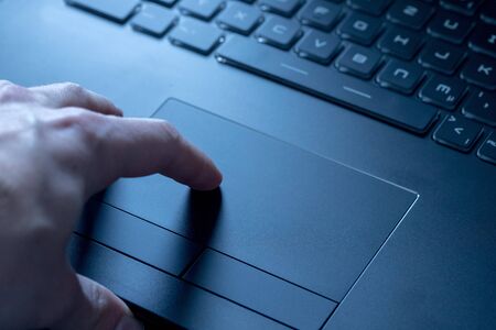 Close up picture of hands using a notebook touchpadの写真素材