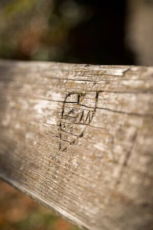Close up of carved heart on a park bank, autumnの写真素材