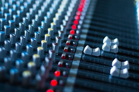Professional music production in a sound recording studio, mixer desk