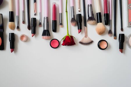 Set of makeup brushes and other accessories. Lipstick, mascara, nail polish, eyeshadow, powder, eyelash and foundation. Products for makeup on white background, top view.の写真素材
