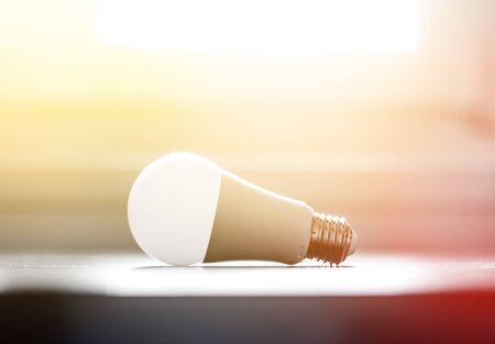 White light bulb lying on a desk, concept for ideas. Sunlight.の写真素材