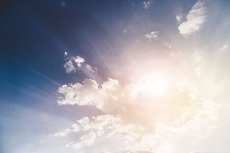 Cloud and bright sunbeams on a blue skyの写真素材