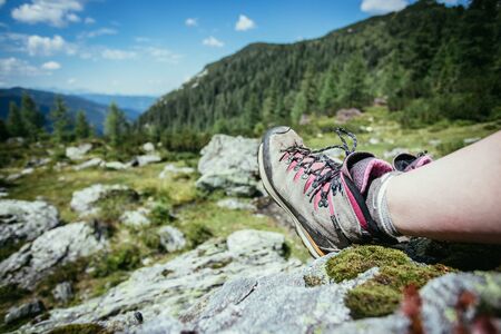 Cut out of a woman in hiking boots who is enjoying the idyllic mountain landscapeの写真素材