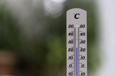 Thermometer close up picture in summer time, blurry background