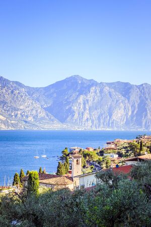 Italian village, blue lake garda and mountainsの写真素材