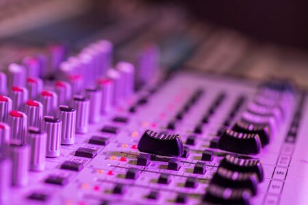 Professional music production in a sound recording studio, mixer desk