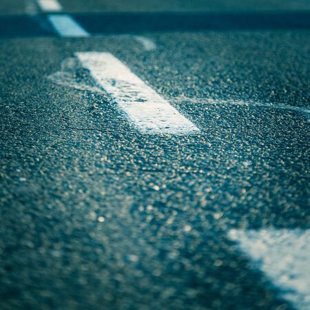 Black rough asphalt road in Austria, closeupの写真素材