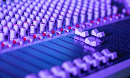 Professional music production in a sound recording studio, mixer desk