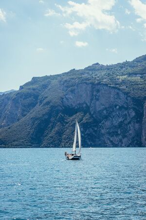 Sailing on lago di garda: Captured from a tourist cruise boat, clear water and mountain landscapeの写真素材