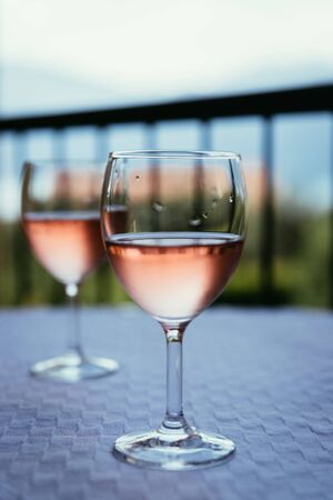 Glass of rose wine outdoors on the balcony. Evening scenery, Italyの写真素材