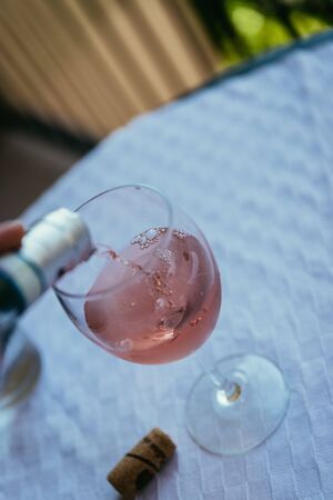 Glass of rose wine outdoors on the balcony. Evening scenery, Italy