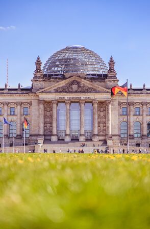 Picture of the Reichstag in Berlin in Springtime, green grass and flowersの写真素材