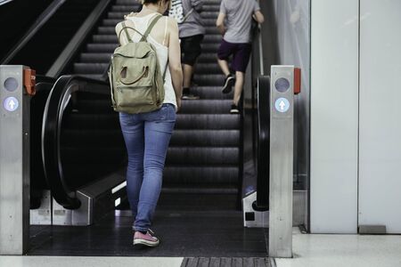 Travelling scene at a train station: young girl and a stairway