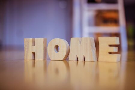 Wooden HOME Letters on the floor of an apartmentの写真素材