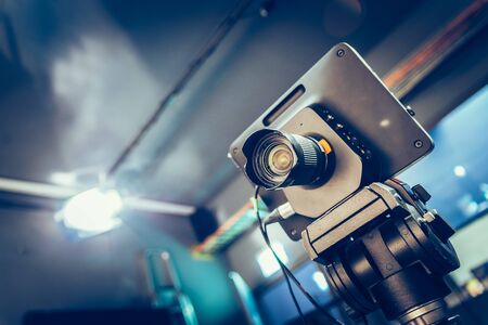 Film camera on a tripod in a television broadcasting studio, spotlights and equipmentの写真素材
