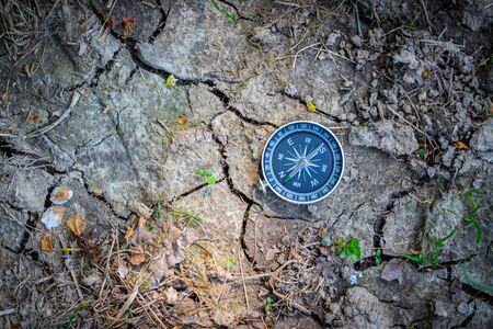 Vintage compass lying on the floor. Adventure and discovery concept.の写真素材