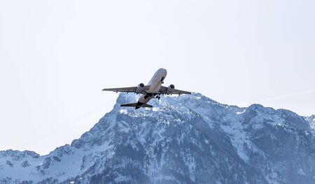 Aircraft is taking off, idyllic mountain range in the backgroundの写真素材