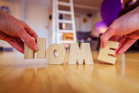 Arranging HOME letters on the floor of an apartmentの写真素材