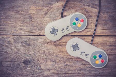 Retro computer gaming controller a rustic wooden background