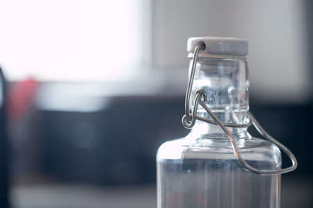Close up of glass bottle in the office, drinking