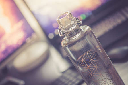 Close up of glass bottle in the office, drinking