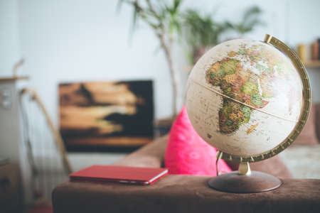 Planning the next journey: Globe in the living room, nobodyの写真素材