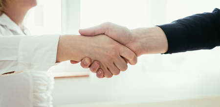 Man and woman are shaking hands, close up image, concept for human relationshipsの写真素材