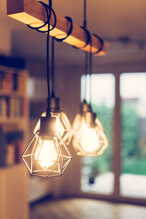 Close up picture of a hanging orange lightbulbs at home, in a restaurant or cafeの写真素材