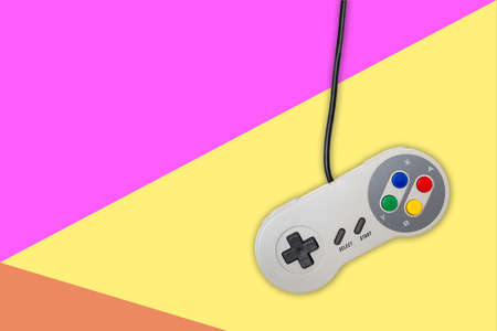 Abstract retro computer gaming controller on colorful background