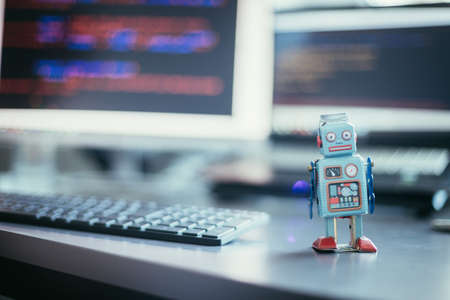Symbol for a chatbot or social bot and algorithms, program code in the background