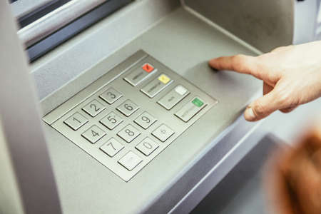 Young woman withdrawing money from a cash machine