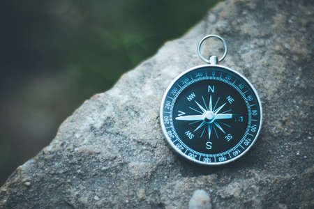 Vintage compass lying on the floor. Adventure and discovery concept.の写真素材