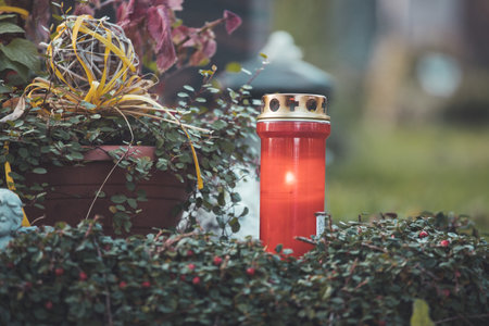 Close up of red candle on a grave at a cemeteryの写真素材