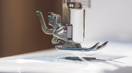 Close up of sewing metal sewing needle with sewing threadの写真素材