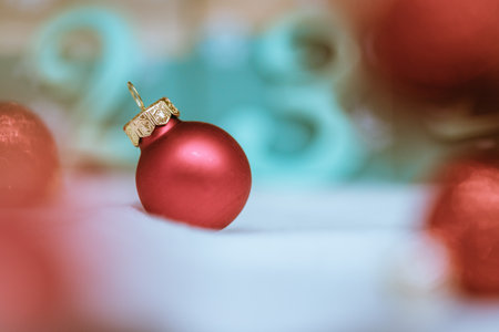 Christmas decoration: Close up of red Christmas baubles, advent calendar in the blurry backgroundの写真素材