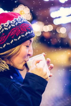 Girl is drinking mulled wine on the Christmas market, funの写真素材