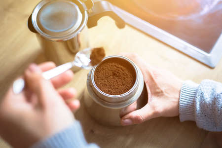 Preparing coffee: Close up of coffee powder in a vintage coffee cookerの写真素材